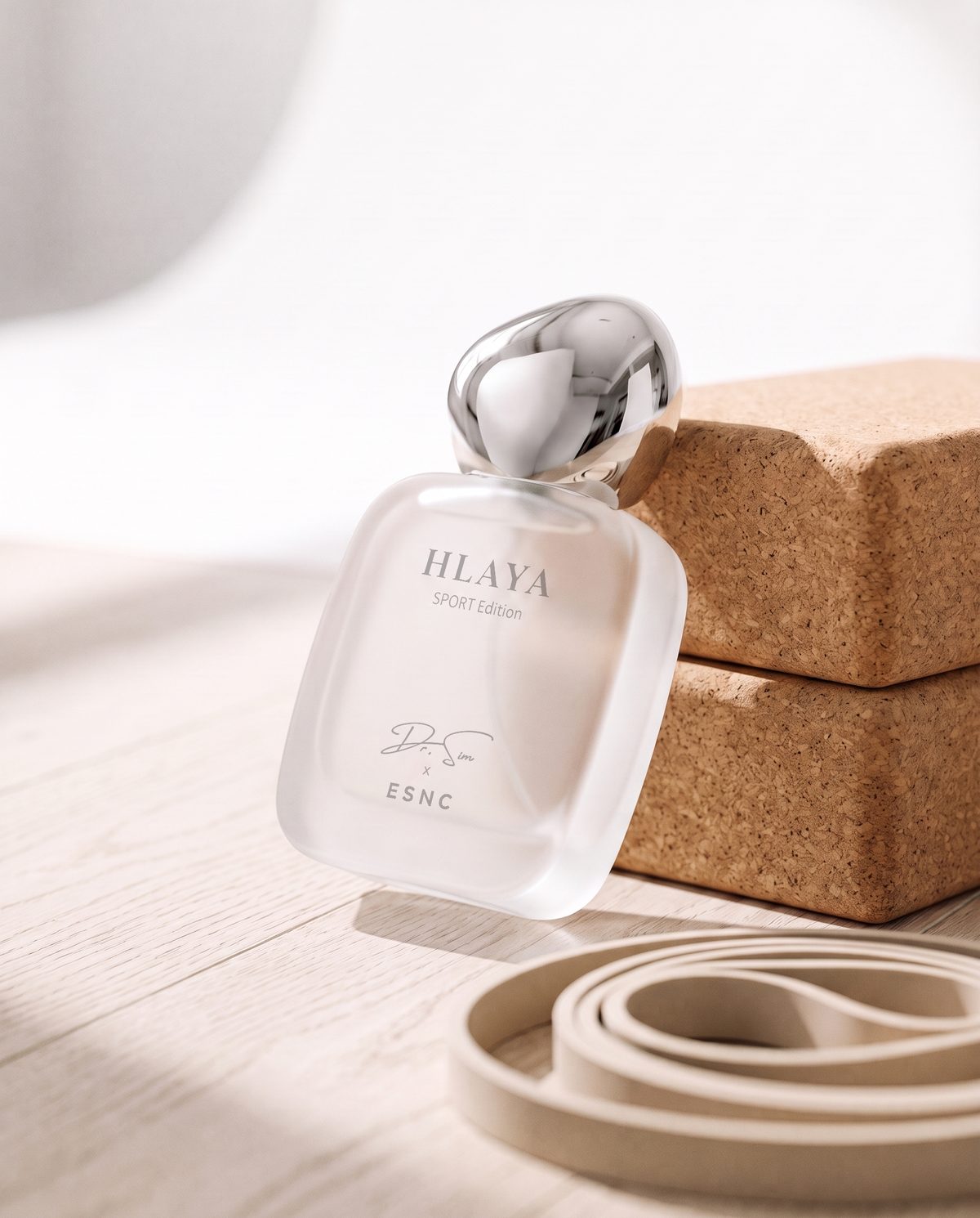 HLAYA tipped back against two cork blocks on an oak floor, a resistance band in front.