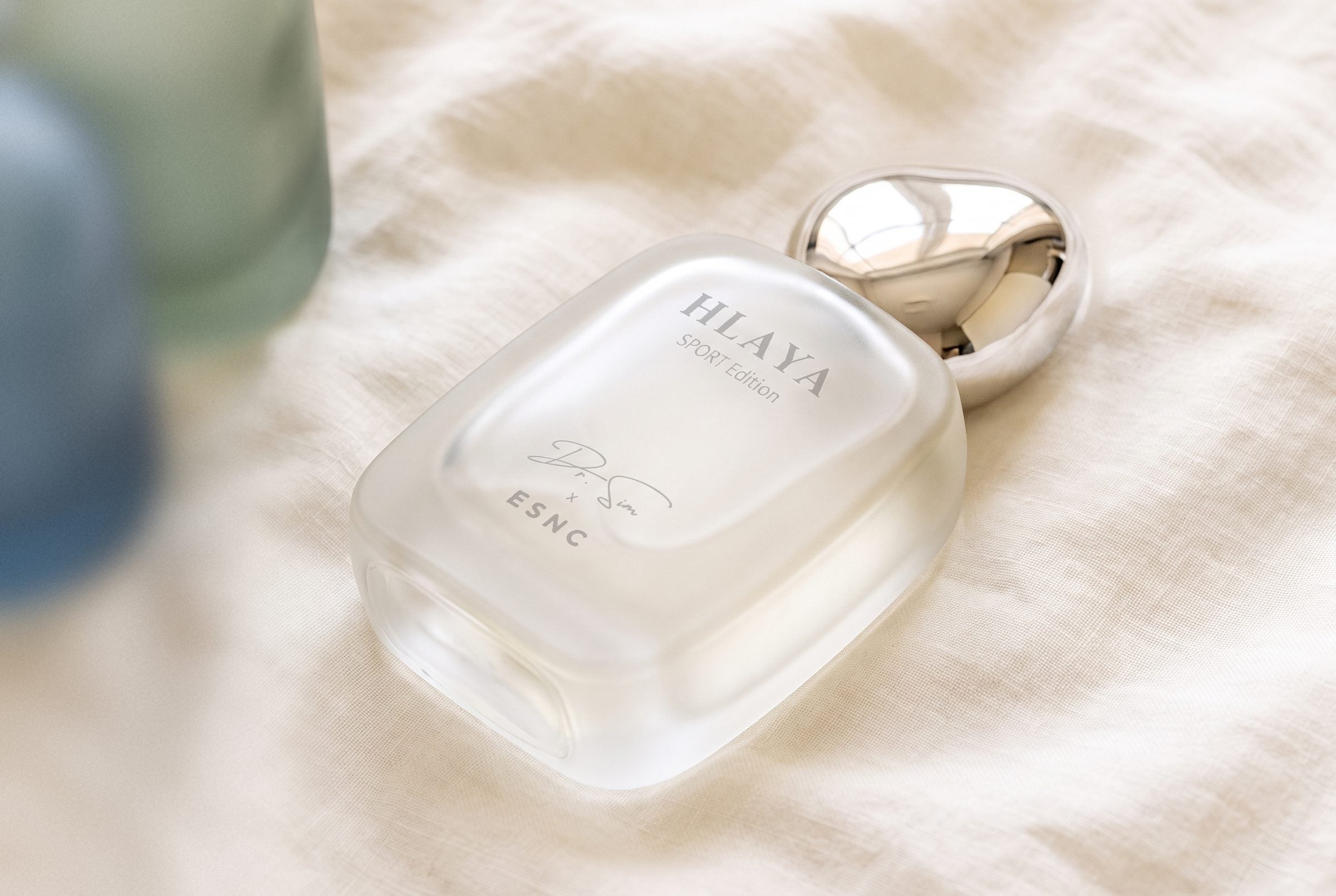 HLAYA lying on its side on ivory linen in soft window light.