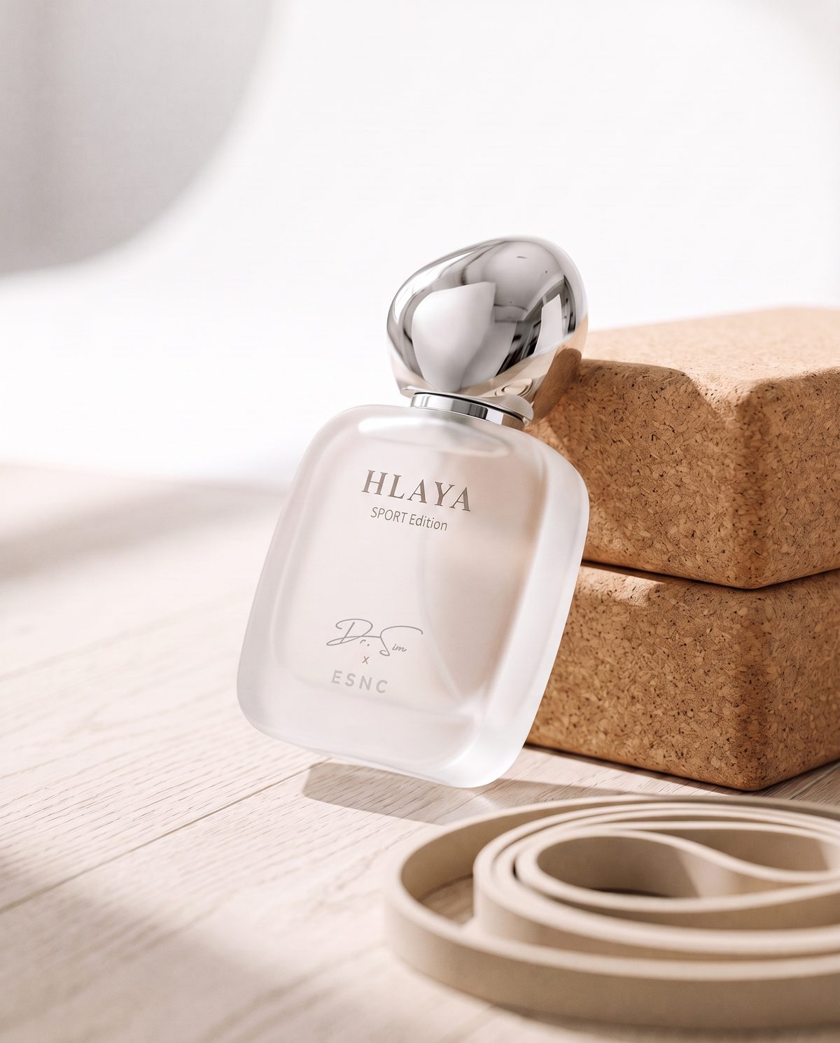 HLAYA tipped back against two cork blocks on an oak floor, a resistance band in front.