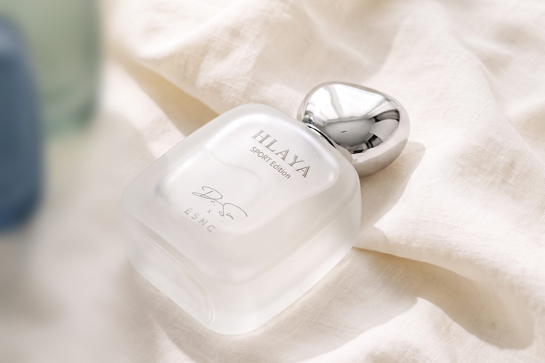 HLAYA lying on its side on ivory linen in soft window light.